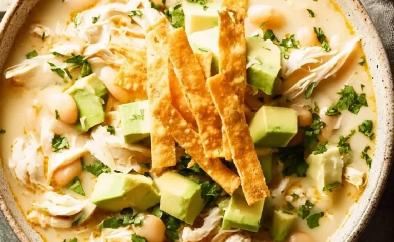 Bowl of creamy white chicken chili topped with cilantro and lime