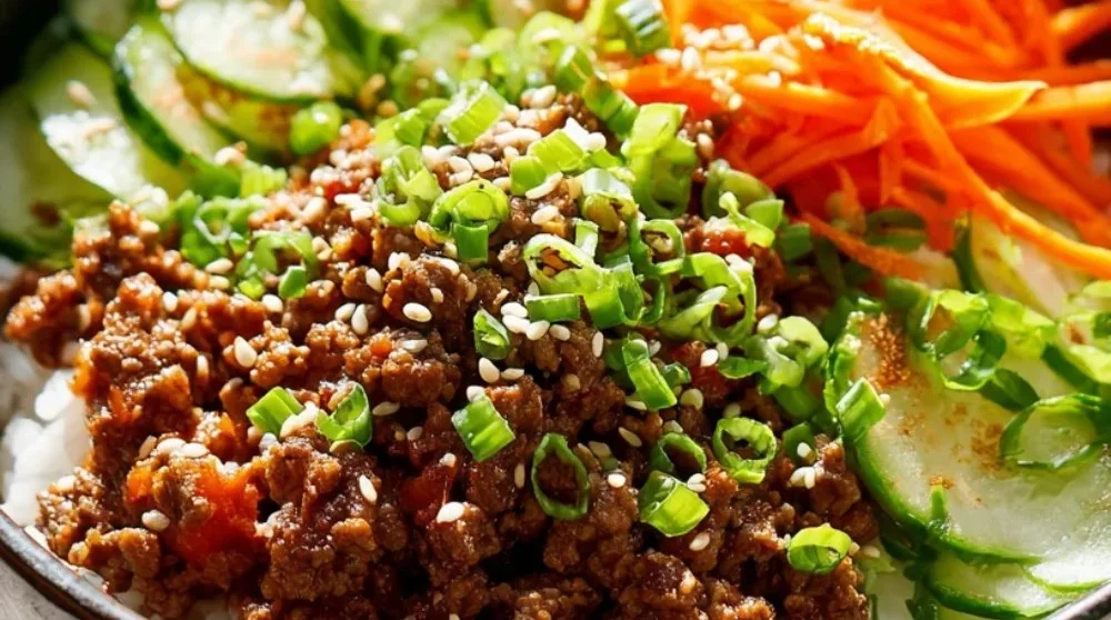 Korean Ground Beef Bowl garnished with fresh vegetables and sesame seeds