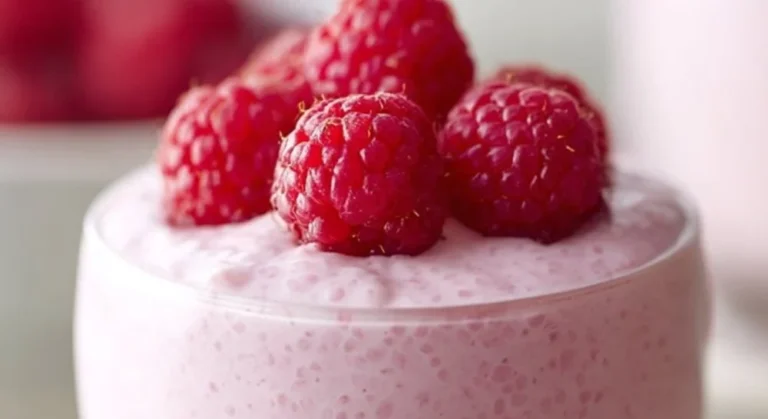 Vanilla Raspberry Chia Pudding topped with fresh raspberries and mint leaves