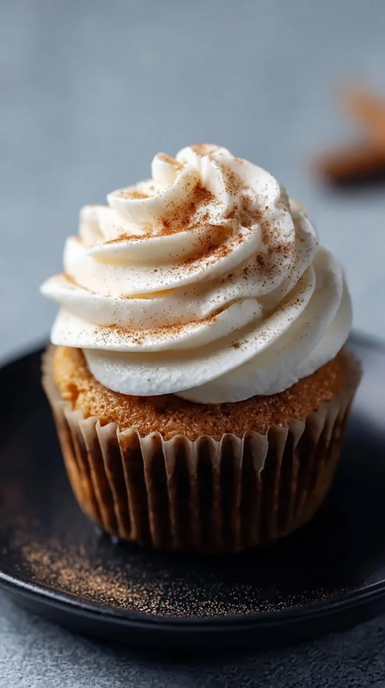 Delicious cinnamon roll cupcakes topped with creamy frosting and a cinnamon swirl